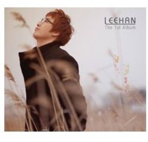 "Album cover featuring a man in a black jacket standing among tall, blurry grasses."
