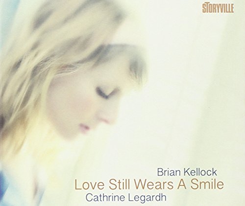 Album cover with a blonde woman's profile and text "Love Still Wears A Smile".