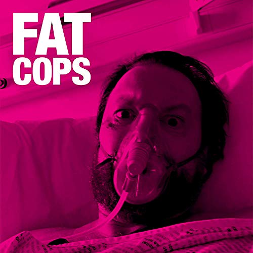 Man lying in bed wearing an oxygen mask, with 'FAT COPS' text overlay in white.