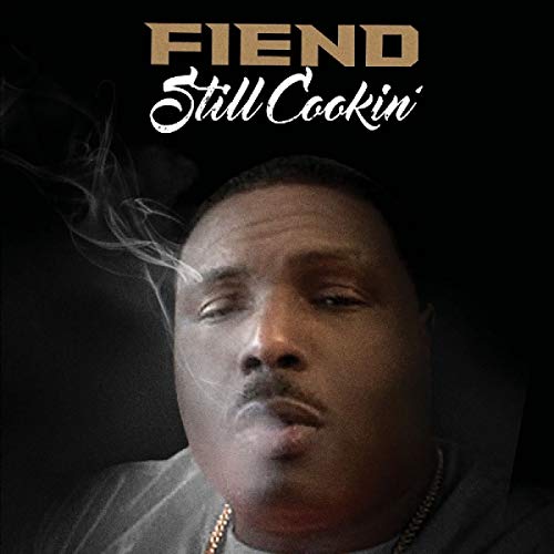 Album cover with a man smoking, titled "Fiend - Still Cookin'" in gold and white text.