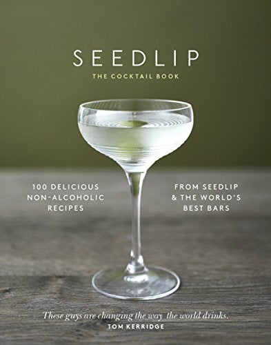 "Book cover with a cocktail glass on a wooden surface, green background."