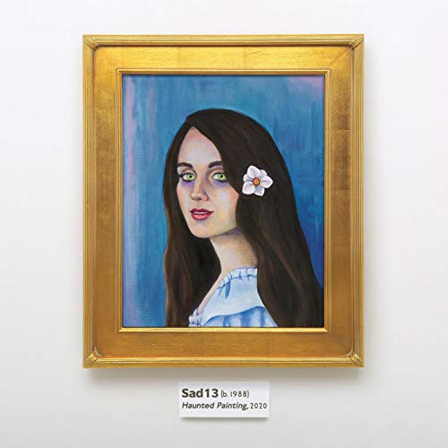 Framed portrait of a woman with long dark hair and a flower behind her ear.