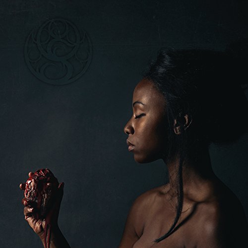 "Album cover featuring a woman holding a bloody heart, dark background, symbolic logo."