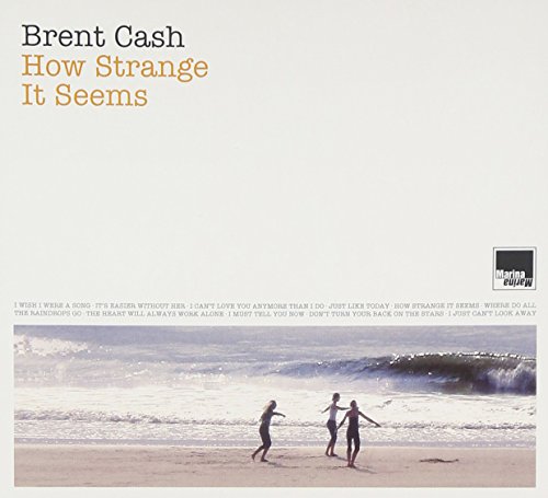 "Album cover featuring three people on a beach with a large wave."
