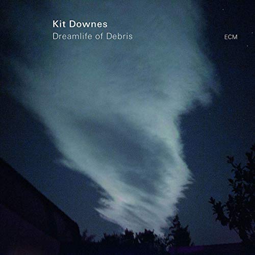 "Album cover with dark sky, white cloud, and silhouetted trees and building."