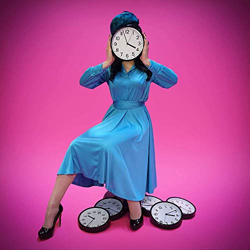 Woman in blue dress holding clock over face, surrounded by clocks on pink background.