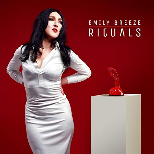 Vinyl album cover featuring a woman in white dress beside a red sculpture.