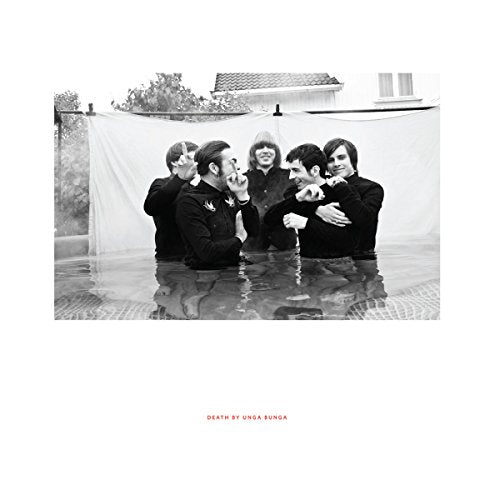 "Black and white album cover with six men standing in water."