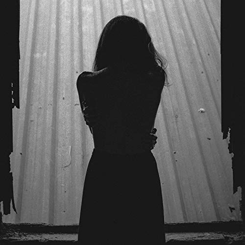 Black and white album cover featuring a silhouette of a woman against a metal wall.