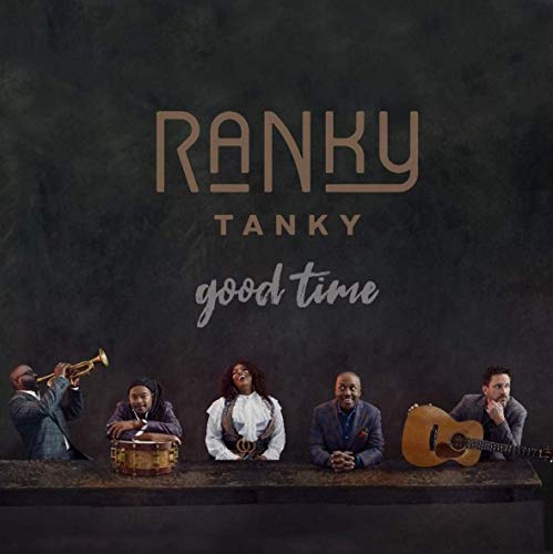 "Album cover featuring five men with musical instruments against a dark background."