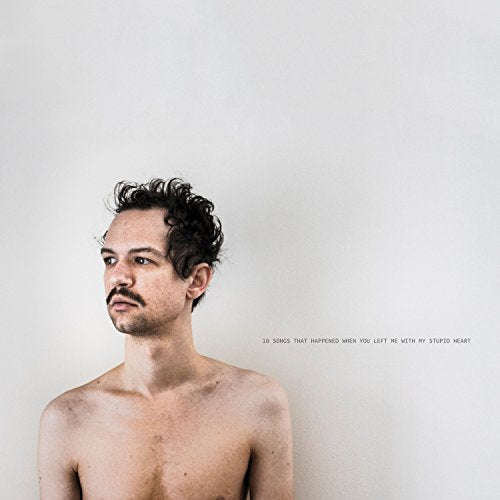 Vinyl album cover featuring a shirtless man with curly hair against a white background.