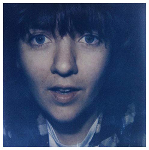 A vinyl record cover featuring a close-up portrait of a woman with dark hair.