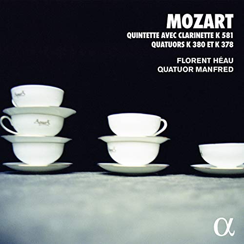 "CD cover featuring stacked white teacups on a gray surface against a black background."