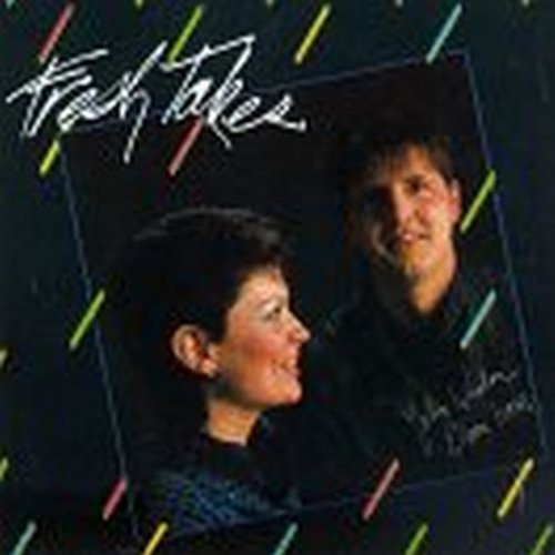 "CD cover with a man and woman, black background, colorful diagonal lines."