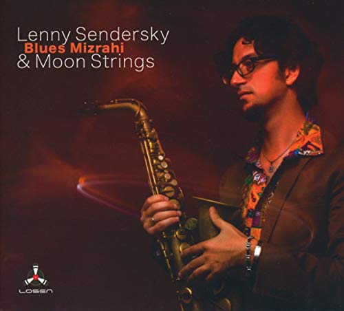 Man holding a saxophone, wearing glasses and a patterned shirt against a red background.