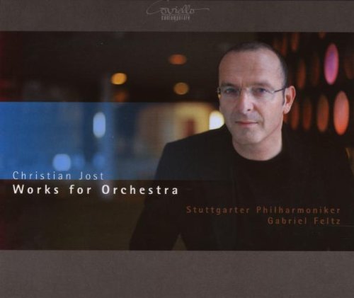 CD cover featuring a man in a black shirt and glasses, blurred background.