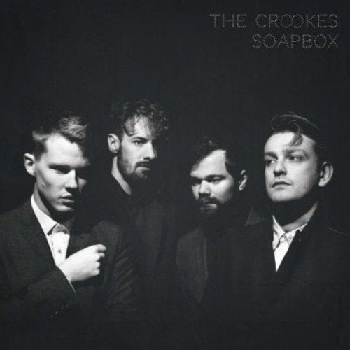 "Black and white CD cover featuring four men in suits against a dark background."