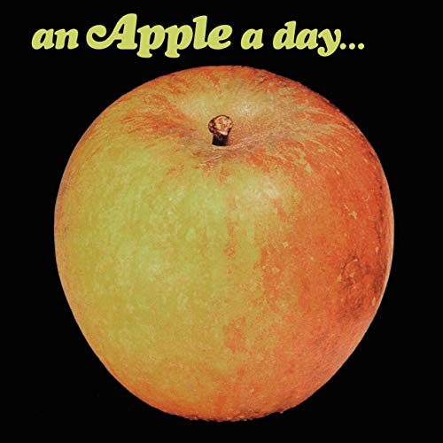 "Album cover featuring a red and yellow apple against a black background."