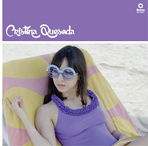 Woman in purple top and sunglasses reclines on a beach chair with yellow and pink stripes.