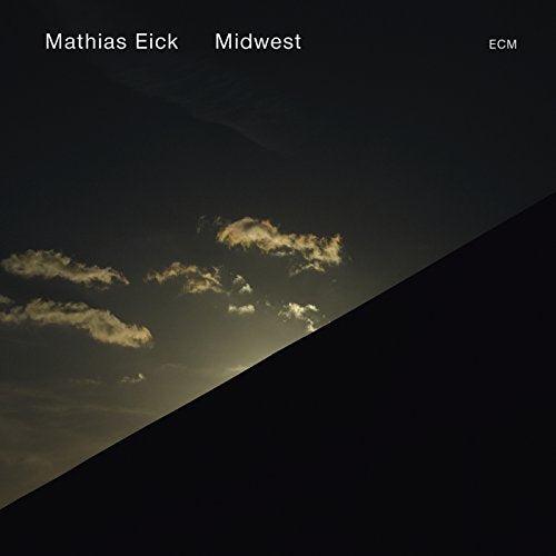 Album cover with dark sky, clouds, and diagonal shadow, titled "Mathias Eick - Midwest".