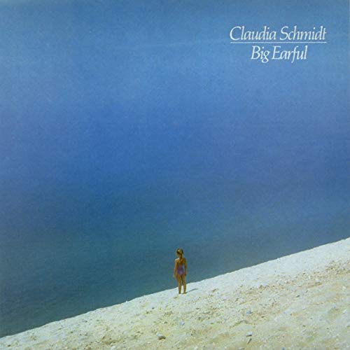 A vinyl record cover featuring a woman standing on a sandy cliff overlooking water.