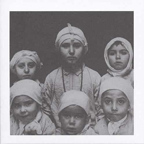 Black and white portrait of five children wearing head coverings.