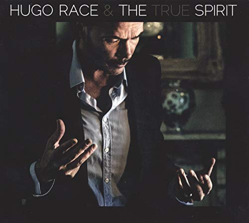 Vinyl album cover featuring a man in a suit, gesturing with his hands.