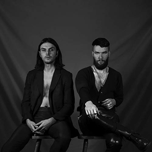 "Black and white album cover featuring two men sitting on stools, looking directly at camera."