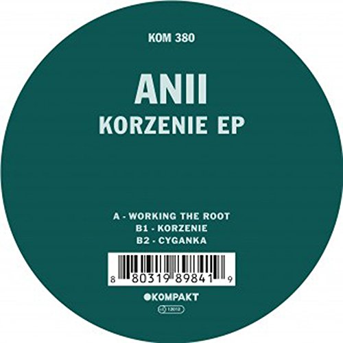 A vinyl record with a green label and white text, displaying a barcode.