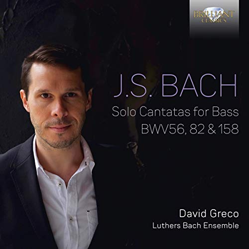 CD cover featuring a man in a suit against a dark background.