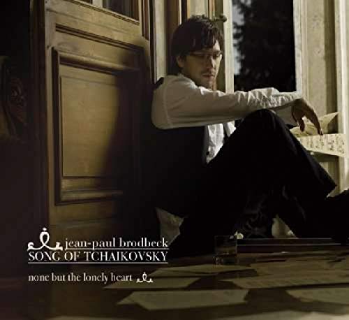 "CD cover featuring a man sitting on the floor by a window."