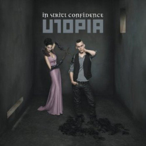 "Album cover with man and woman standing in a dark room."