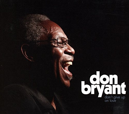 Album cover featuring a man with glasses, singing, against a black background.