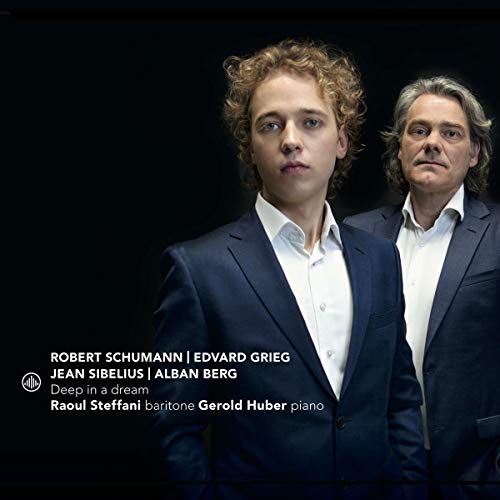 "CD cover with two men in blue suits against a black background."