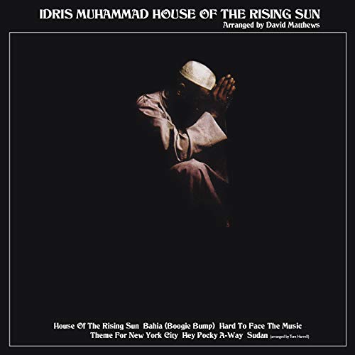 Album cover with man in white robe praying, against a black background.