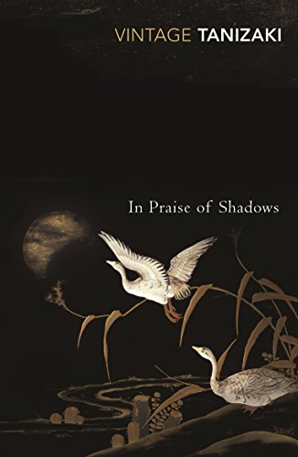 Book cover: "In Praise of Shadows" with white geese, reeds, and a full moon.