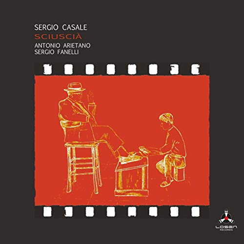"Album cover with red film strip illustration of two men on black background."
