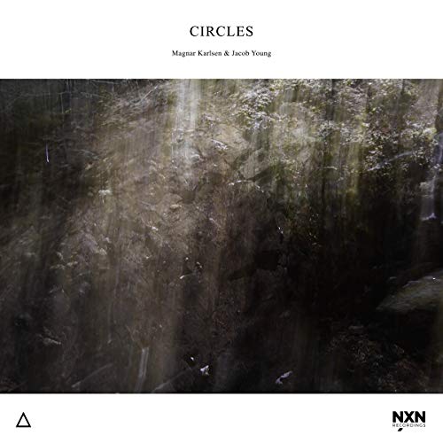 A CD cover with a dark, misty forest scene and white borders.