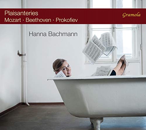 "Woman in a bathtub surrounded by sheet music, classical music album cover."