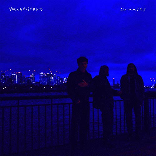 "CD album cover with three silhouetted figures against a blue-lit cityscape at night."