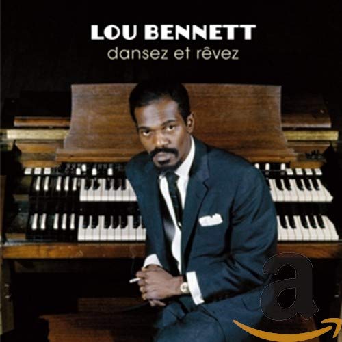 "Album cover with man in suit sitting in front of an organ."