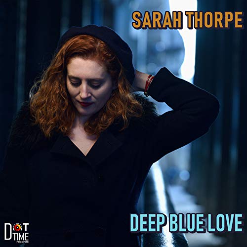 Album cover featuring a woman with red hair wearing a black beret and coat.