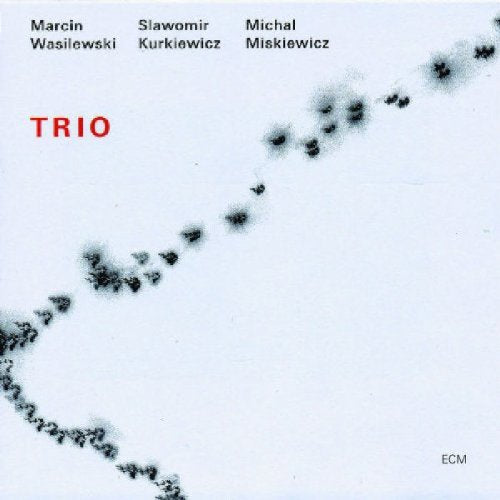 A white album cover with red and black text and a diagonal splatter pattern.