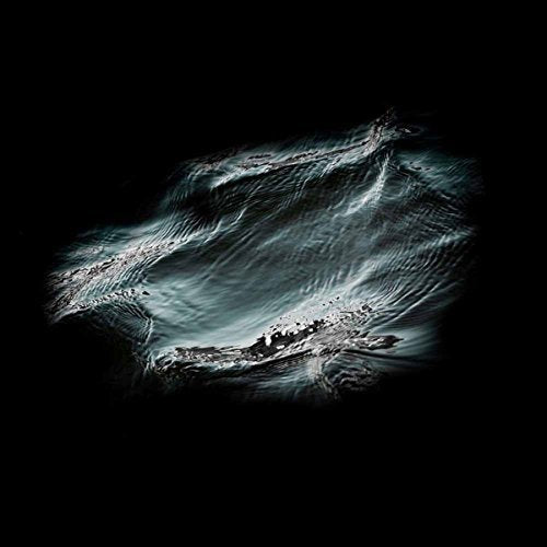 The image is a dark, abstract representation with swirling white and blue patterns on a black background. Alt text: Abstract dark image with swirling white and blue patterns on black background.