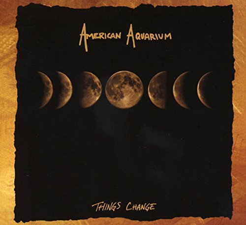 "Album cover with lunar phases on black background, gold text and torn edge effect."