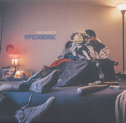 Vinyl album cover with a messy bed and clothes, lit by lamps.