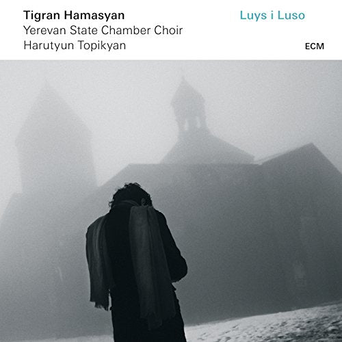 CD album cover with a man standing before a foggy church silhouette.