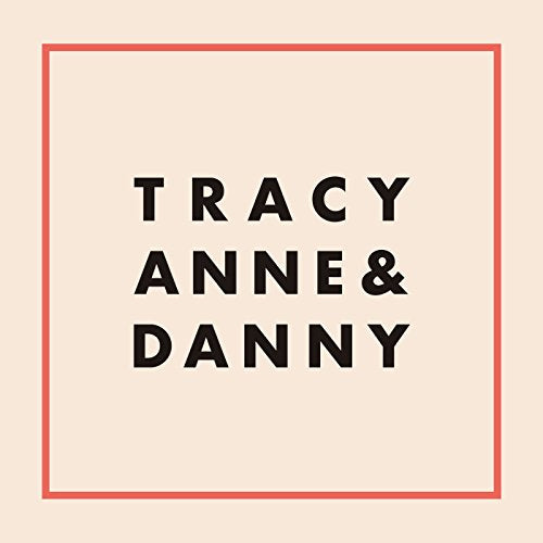 The image shows a pale peach square with a thin red border and black text inside. Alt text: Beige square with red border and "Tracy Anne & Danny" in black text.