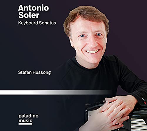 CD cover featuring a man with short brown hair, smiling, resting hands on a keyboard.