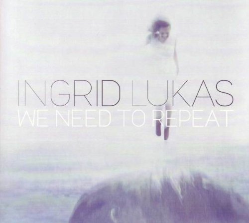 "Album cover with artist name and title, featuring a blurred woman in white dress."